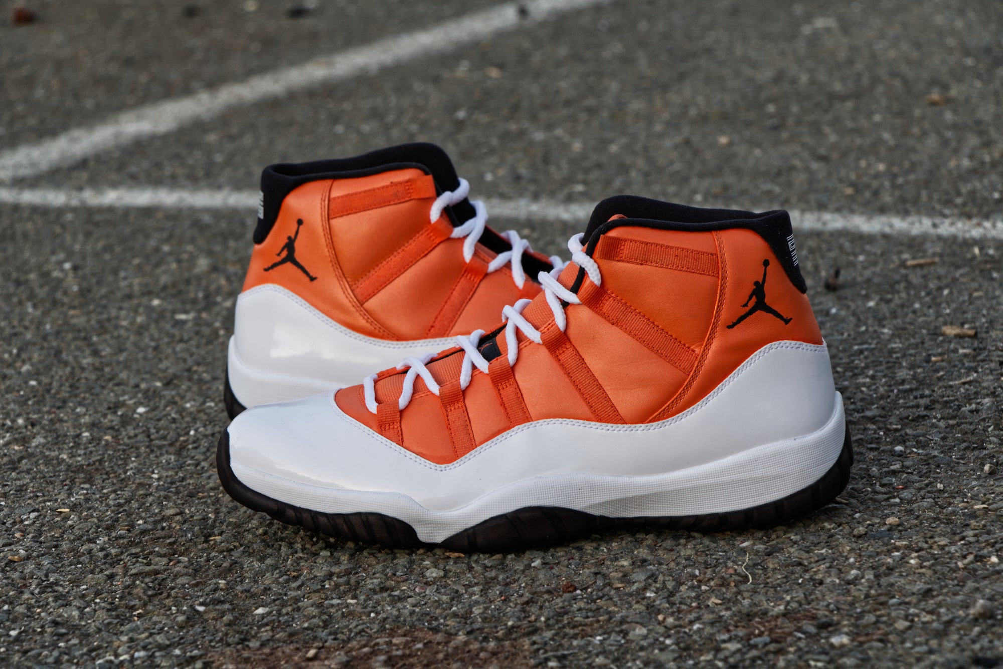 white and orange jordans 11s